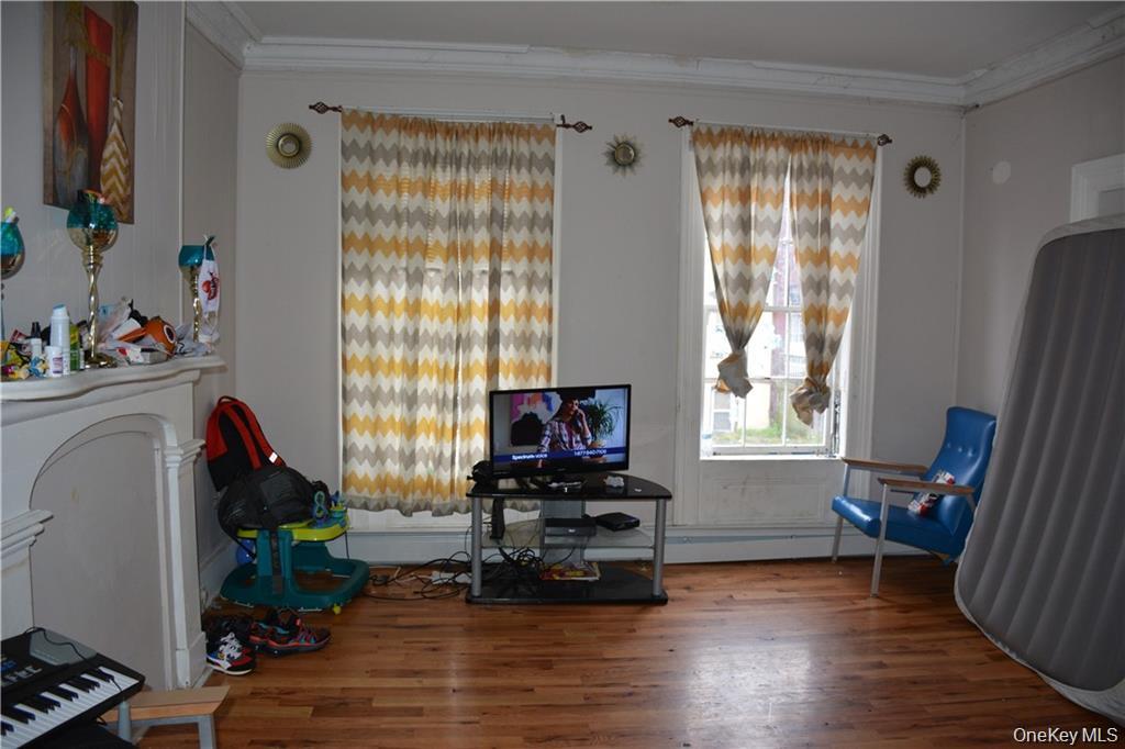 82 Lander Street Newburgh, NY 12550 - Photo 3 of 6 a living room with furniture and a window