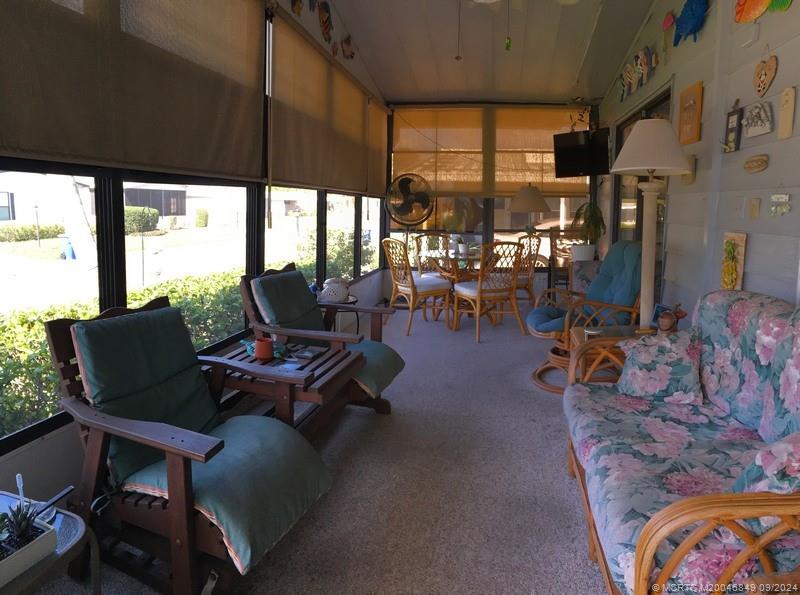 16241 Southwest Five Wood Way Indiantown, FL 34956 - Photo 2 of 10 a living room with patio furniture and a large window