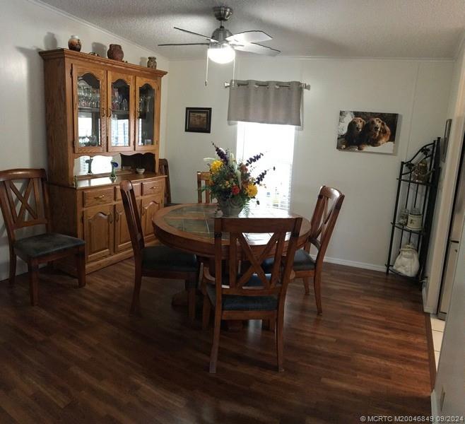 16241 Southwest Five Wood Way Indiantown, FL 34956 - Photo 4 of 10 a view of a dining room with furniture and wooden floor