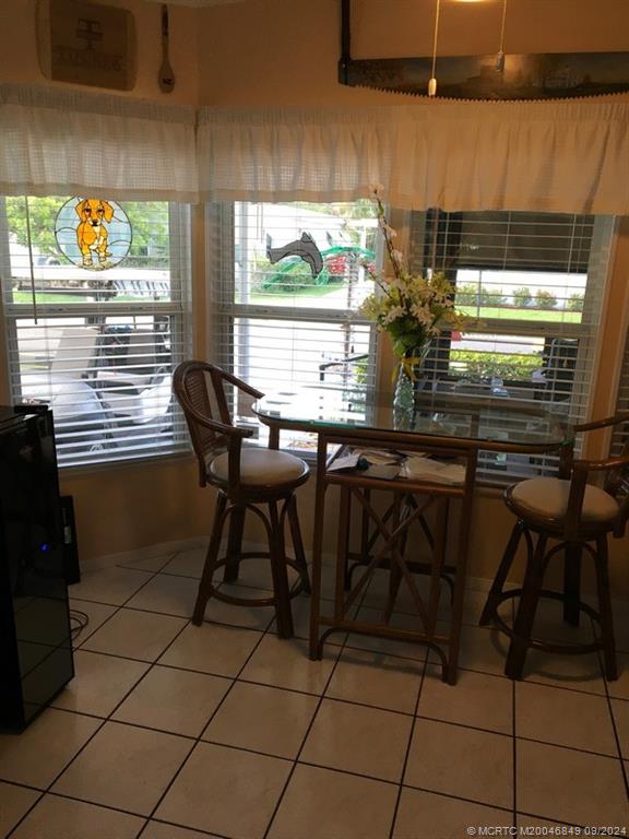 16241 Southwest Five Wood Way Indiantown, FL 34956 - Photo 5 of 10 a table and chairs in a kitchen next to a window