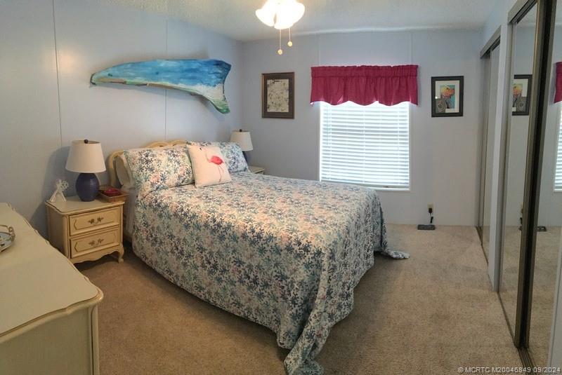 16241 Southwest Five Wood Way Indiantown, FL 34956 - Photo 6 of 10 a bedroom with a bed and a window