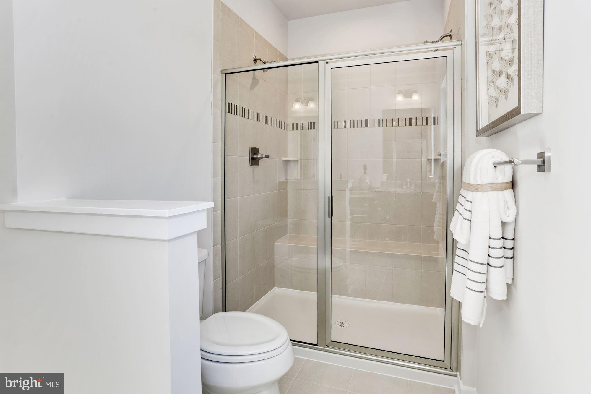 7920 Brandy Station Road, Unit SERENADE Hanover, MD 21076 - Photo 19 of 30 a bathroom with a shower and a toilet