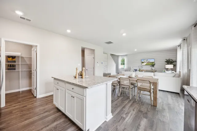a kitchen with a sink cabinets and wooden floor