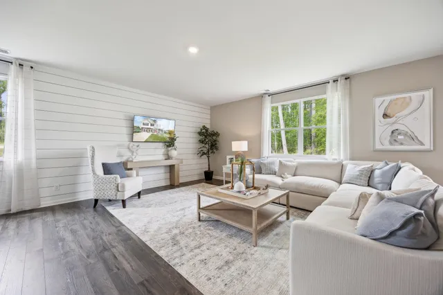 a living room with furniture and wooden floor