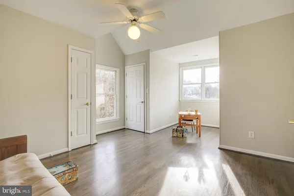 a view of a room with wooden floor and windows