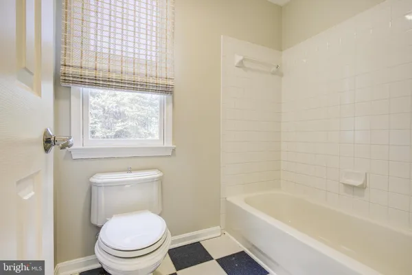a view of a kitchen with a sink and dishwasher a refrigerator with white cabinets