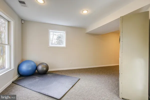 a living room with furniture and a lamp