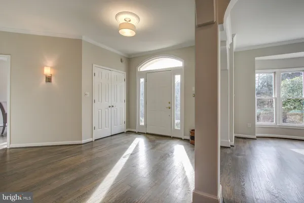 a spacious bedroom with a bed and a chandelier