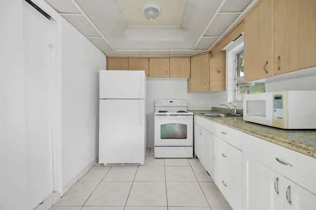 a view of a livingroom with a furniture and floor to ceiling window
