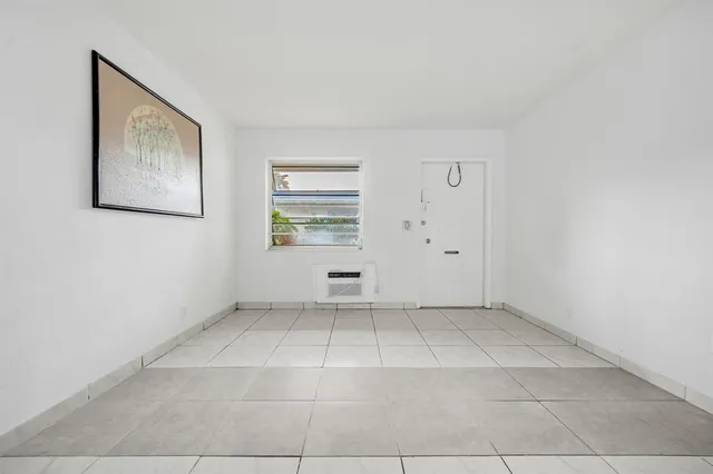 a bedroom with a bed and a potted plant