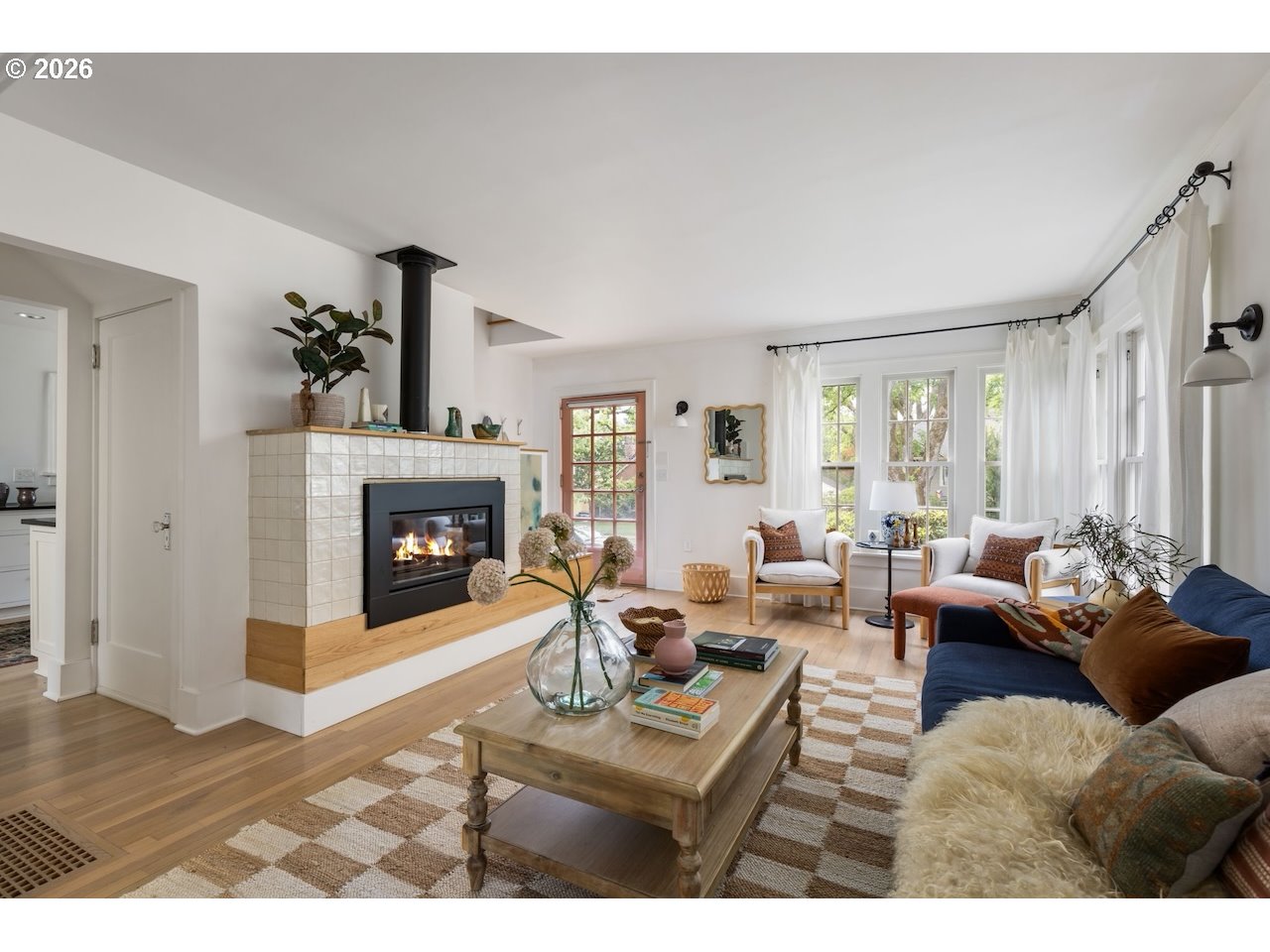 7416 Southeast 36th Avenue Portland, OR 97202 - Photo 8 of 45 a living room with furniture a fireplace and a large window