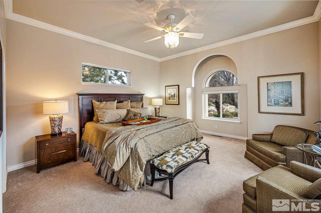 1585 Star Way Reno, NV 89511 - Photo 14 of 25 a bedroom with a bed couches chair and a large window