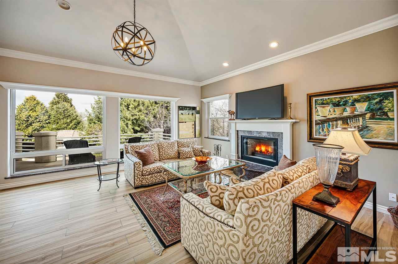 1585 Star Way Reno, NV 89511 - Photo 9 of 25 a living room with furniture a flat screen tv and a fireplace