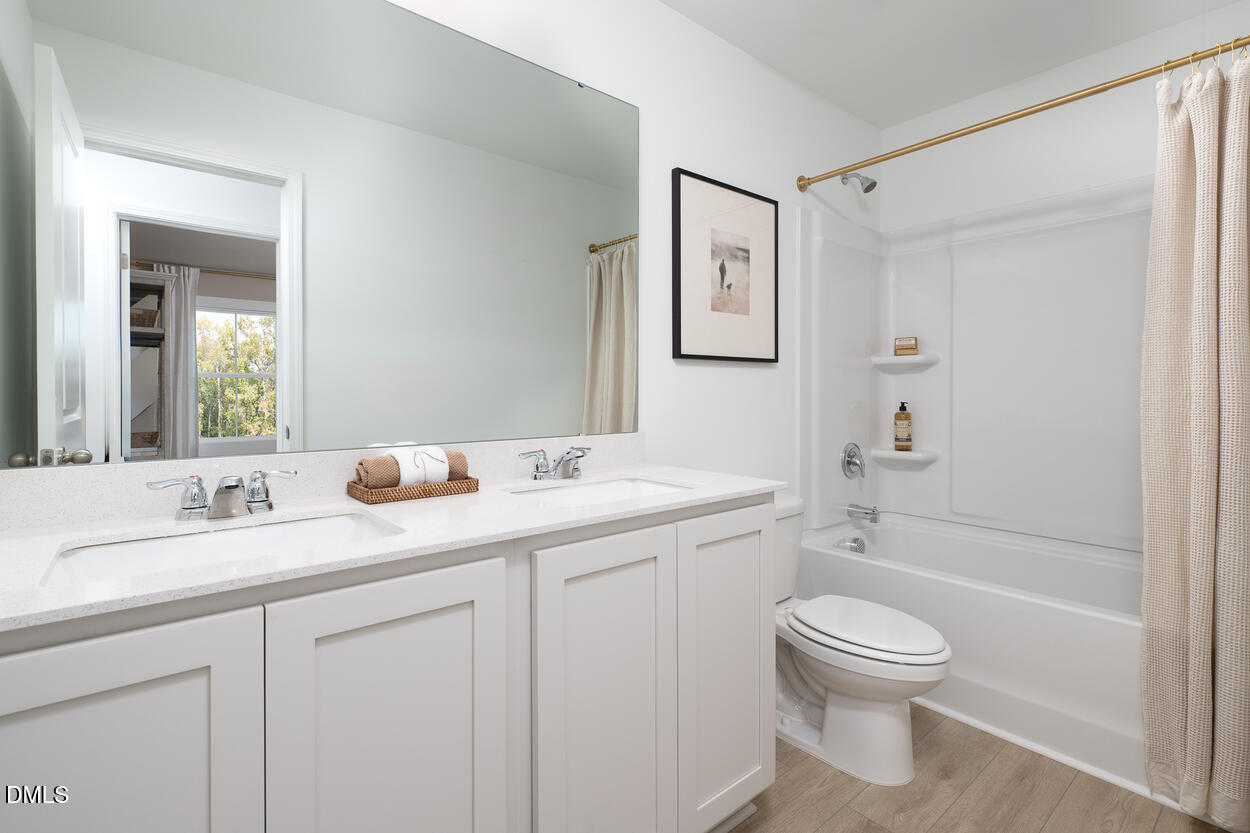 1513 Mirth Court Rolesville, NC 27571 - Photo 18 of 30 a bathroom with a sink a toilet and shower