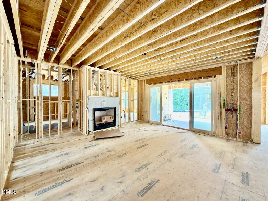 1504 Strothmore Court Raleigh, NC 27615 - Photo 23 of 32 a view of an empty room with a fireplace and a window