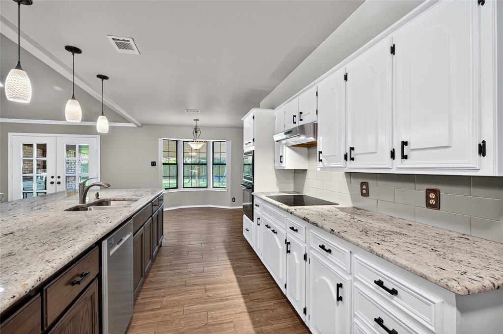1610 Idlewood Drive Sherman, TX 75092 - Photo 12 of 31 a kitchen with sink stove and center with wooden floor