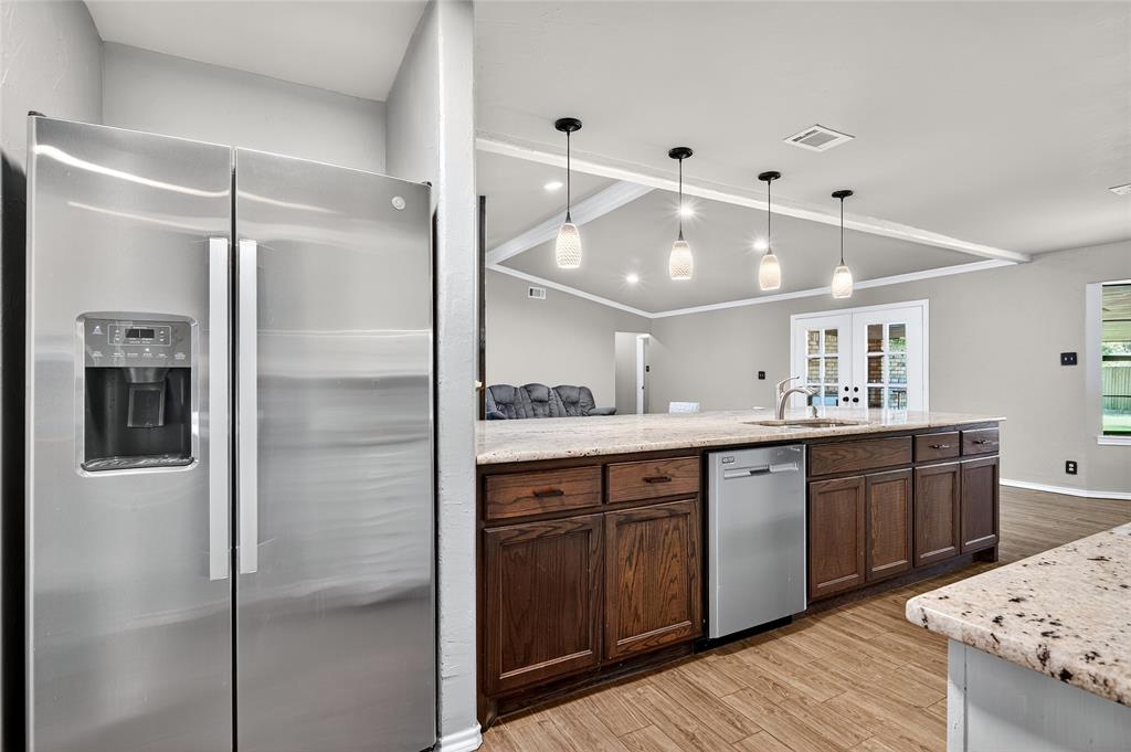 1610 Idlewood Drive Sherman, TX 75092 - Photo 14 of 31 a large kitchen with a sink and refrigerator