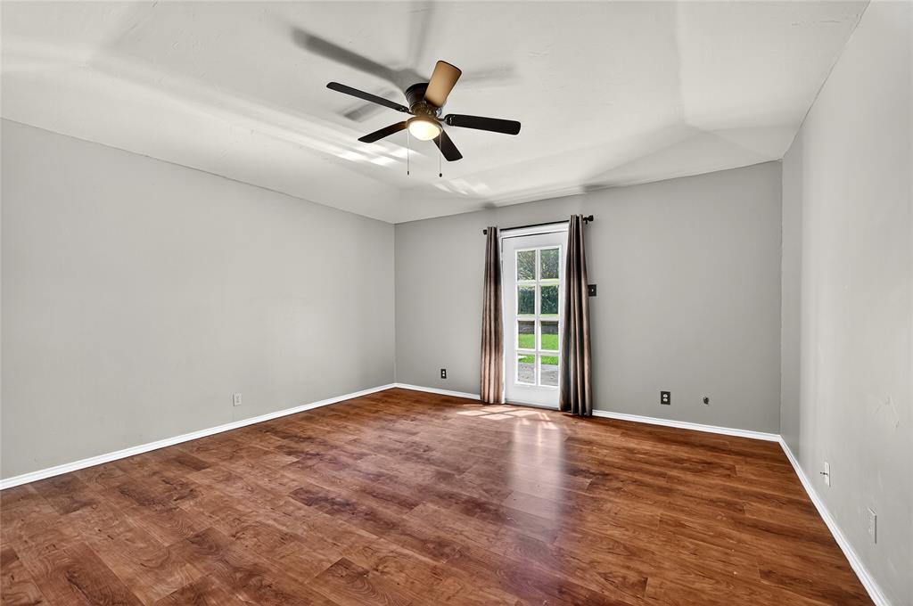 1610 Idlewood Drive Sherman, TX 75092 - Photo 19 of 31 an empty room with wooden floor and windows