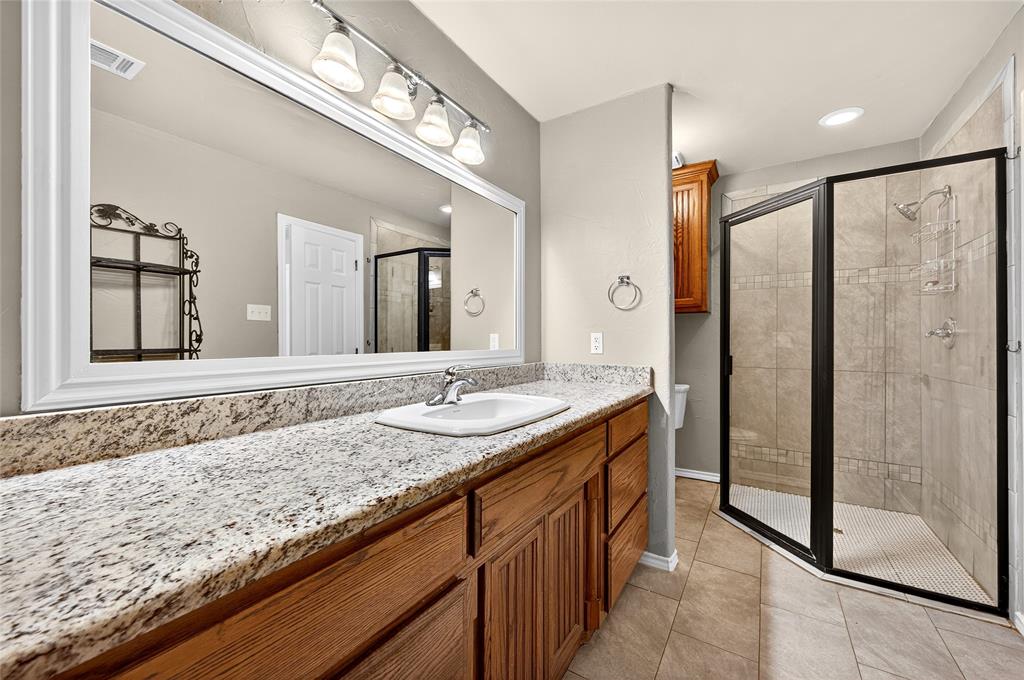 1610 Idlewood Drive Sherman, TX 75092 - Photo 23 of 31 a bathroom with a granite countertop sink mirror and