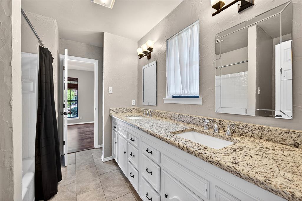 1610 Idlewood Drive Sherman, TX 75092 - Photo 26 of 31 a bathroom with a granite countertop sink and a mirror