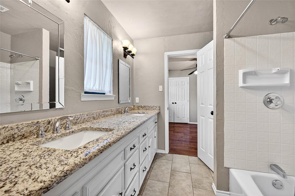 1610 Idlewood Drive Sherman, TX 75092 - Photo 27 of 31 a bathroom with a granite countertop sink and a mirror