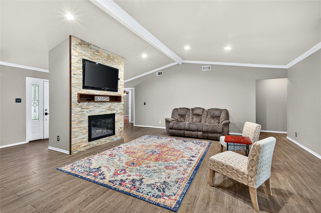 1610 Idlewood Drive Sherman, TX 75092 - Photo 7 of 31 a living room with furniture or flat screen tv and a fireplace