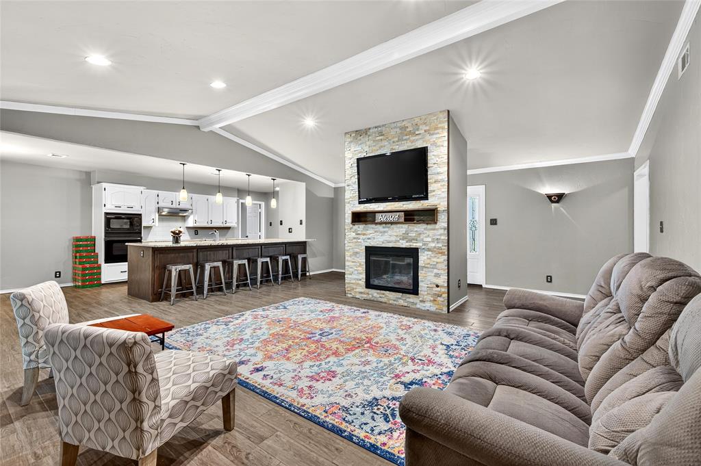 1610 Idlewood Drive Sherman, TX 75092 - Photo 8 of 31 a living room with furniture flat screen tv and a fireplace