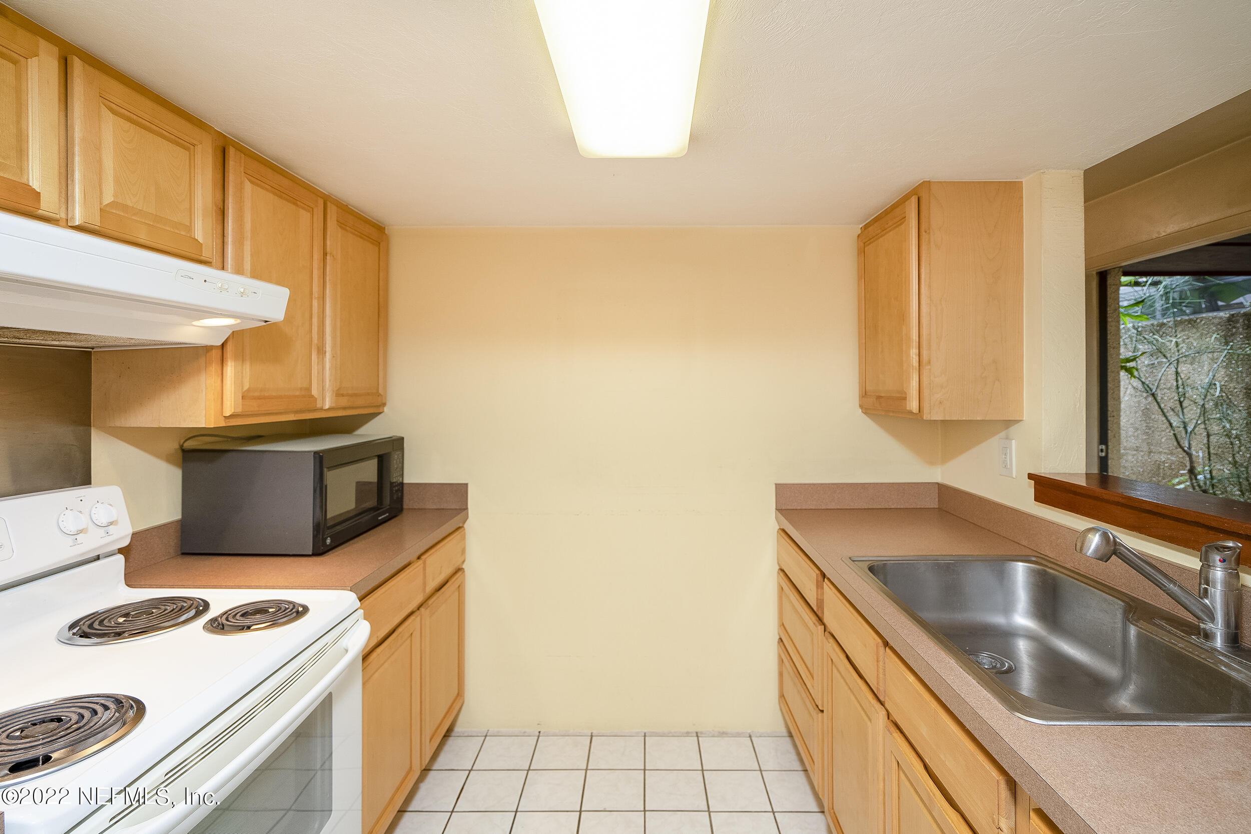 3403 Sanddollar Court St. Augustine, FL 32084 - Photo 19 of 47 a kitchen with granite countertop a sink a stove top oven and cabinetry