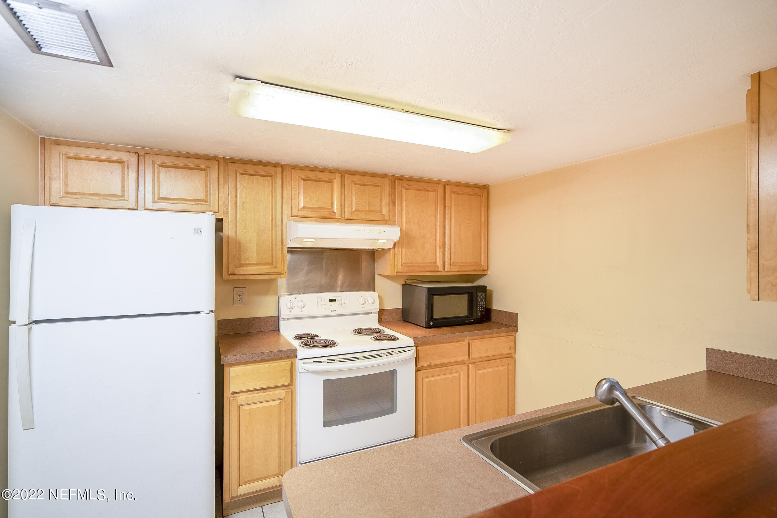 3403 Sanddollar Court St. Augustine, FL 32084 - Photo 4 of 47 a kitchen with a sink a stove and refrigerator