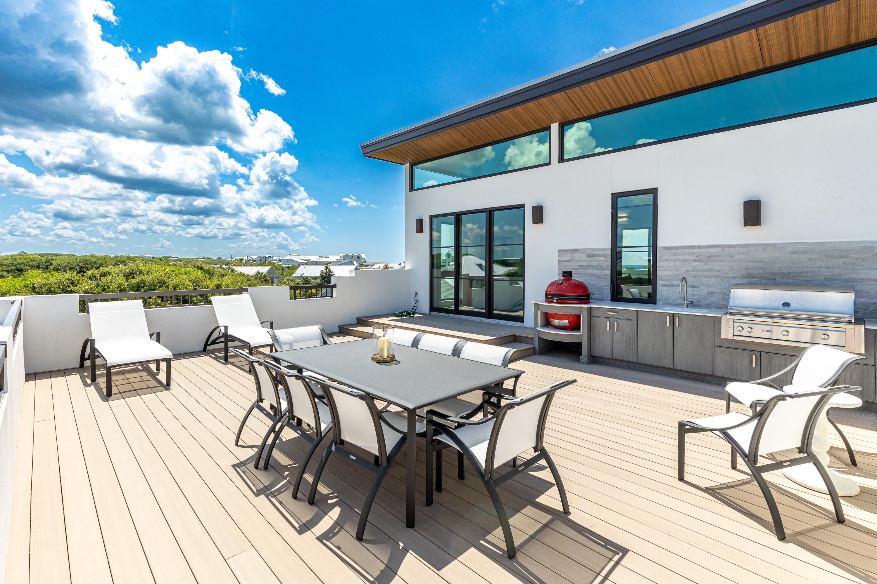 33 Camp Creek Point Dr Inlet Beach Inlet Beach, FL 32461 - Photo 12 of 110 a view of a patio with a dining table and chairs with wooden floor