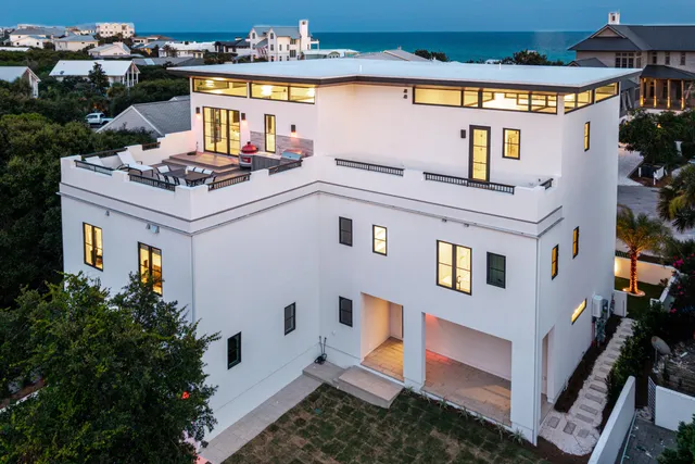 a kitchen that has a lot of cabinets in it and wooden floor
