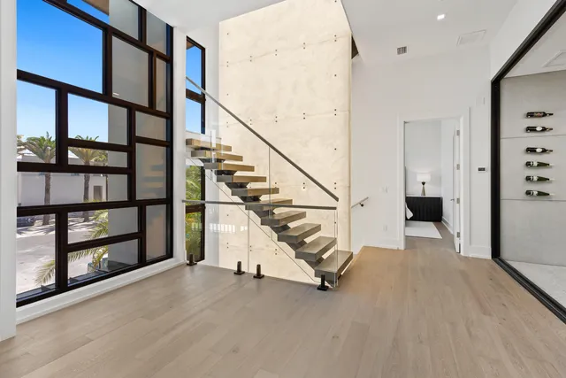 a bedroom with a bed and a flat tv screen on dresser