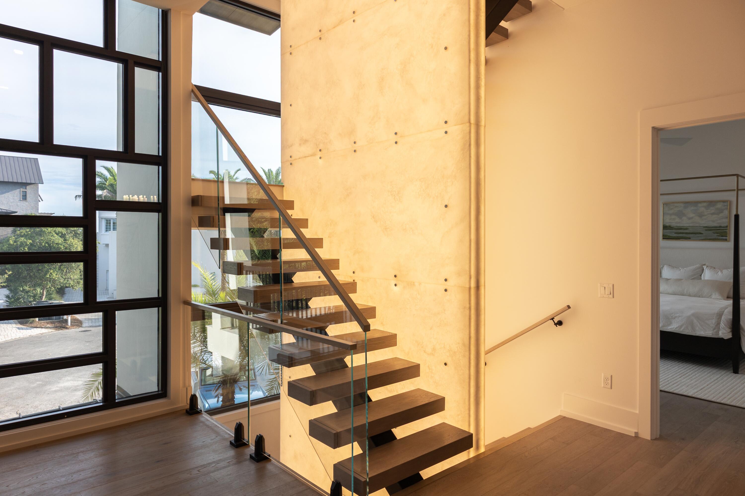 33 Camp Creek Point Dr Inlet Beach Inlet Beach, FL 32461 - Photo 25 of 110 a view of staircase with lots of frames on wall and a window