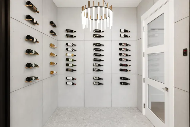 a living room with furniture a large window and a chandelier