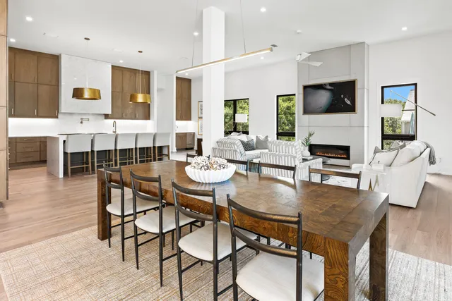 a bathroom with a sink a toilet a mirror and shower