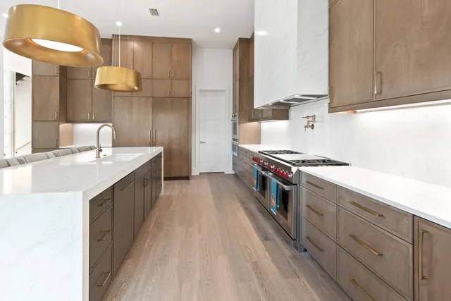 a bedroom with a white bed and wooden floor