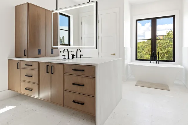 a bathroom with a sink a toilet and a window