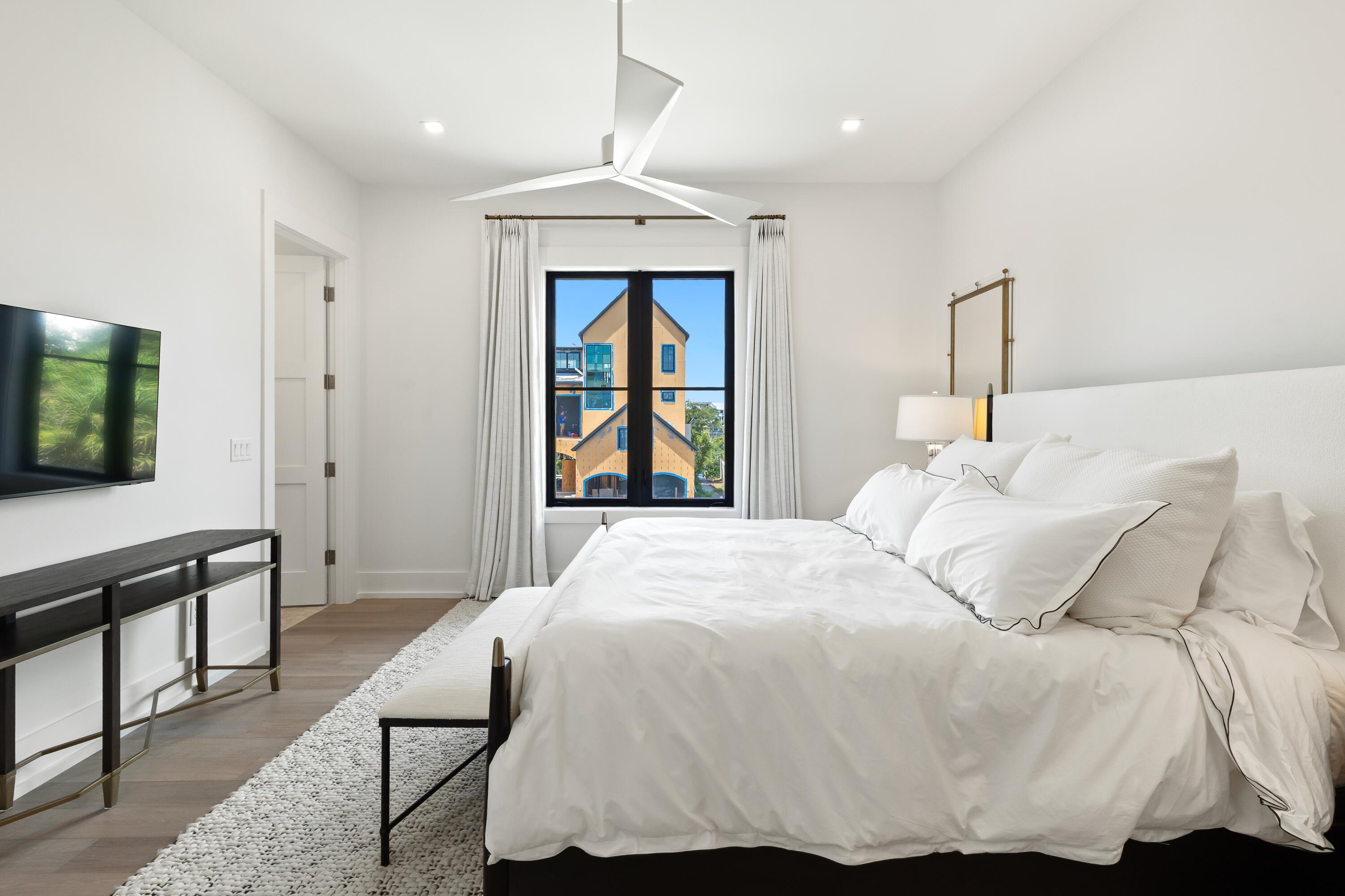 33 Camp Creek Point Dr Inlet Beach Inlet Beach, FL 32461 - Photo 46 of 110 a bedroom with a bed and a flat tv screen on dresser