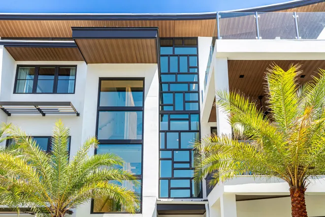 a view of a patio with a dining table and chairs with wooden floor