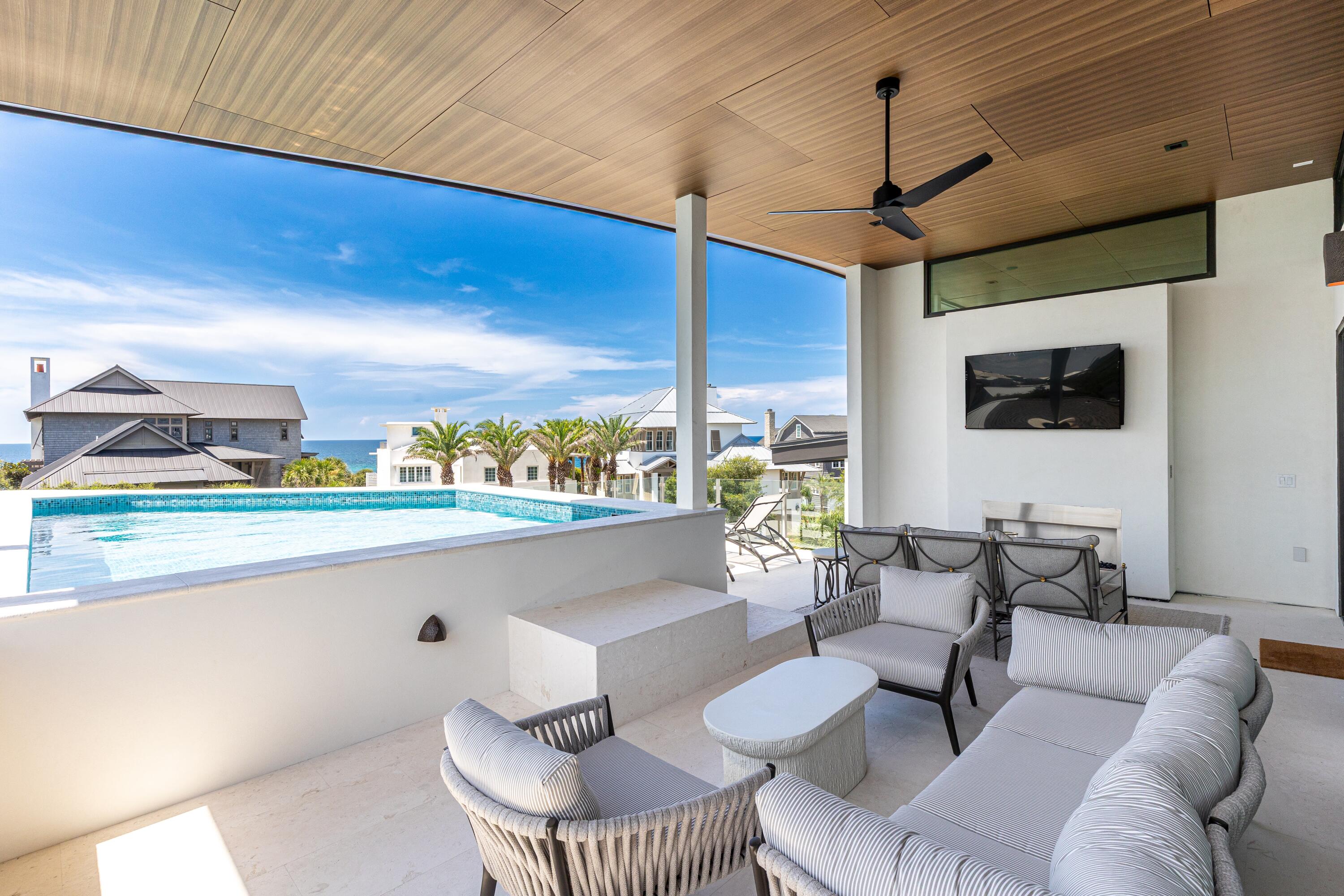 33 Camp Creek Point Dr Inlet Beach Inlet Beach, FL 32461 - Photo 58 of 110 a living room with couches a flat screen tv and kitchen view