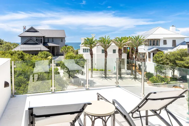 a living room with furniture kitchen view and a large mirror
