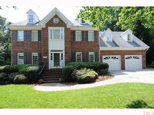 7705 Lambroll Lane Raleigh, NC 27613 - Photo 1 of 12 a front view of a house with a yard and garage