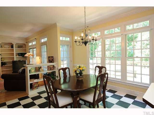 7705 Lambroll Lane Raleigh, NC 27613 - Photo 3 of 12 a view of a dining room with furniture and chandelier