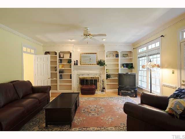 7705 Lambroll Lane Raleigh, NC 27613 - Photo 4 of 12 a living room with furniture and a fireplace