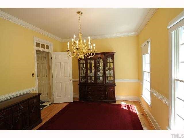 7705 Lambroll Lane Raleigh, NC 27613 - Photo 5 of 12 a view of entryway with chandelier and wooden floor
