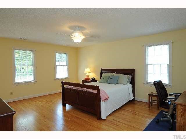 7705 Lambroll Lane Raleigh, NC 27613 - Photo 6 of 12 a living room with a bed furniture and a window