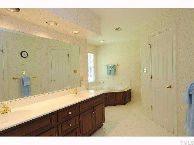 7705 Lambroll Lane Raleigh, NC 27613 - Photo 7 of 12 a bathroom with a granite countertop sink mirror and double