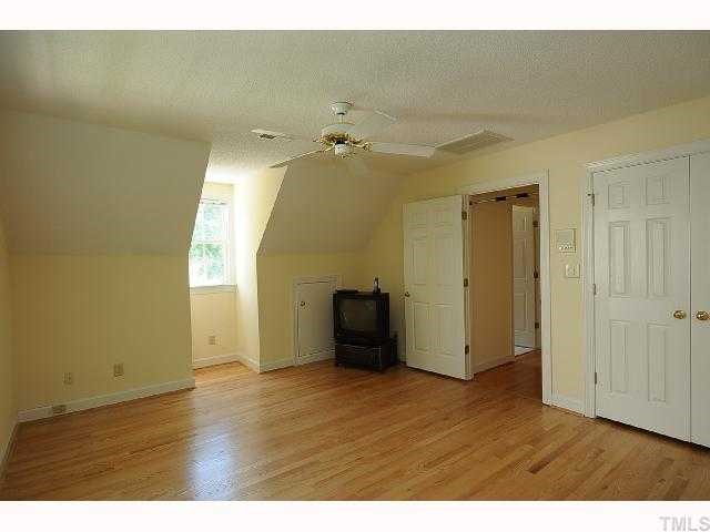 7705 Lambroll Lane Raleigh, NC 27613 - Photo 9 of 12 a view of an empty room with wooden floor