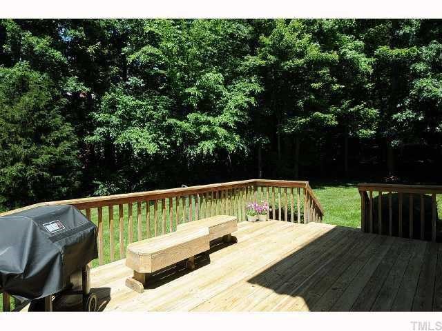 7705 Lambroll Lane Raleigh, NC 27613 - Photo 10 of 12 a view of a roof deck with couches and wooden fence