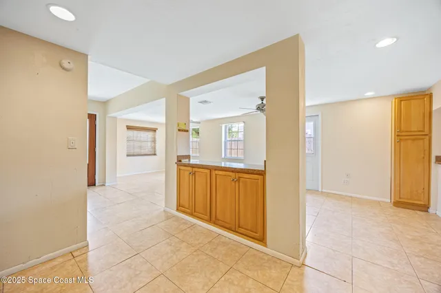 a view of a hallway with wooden shelves